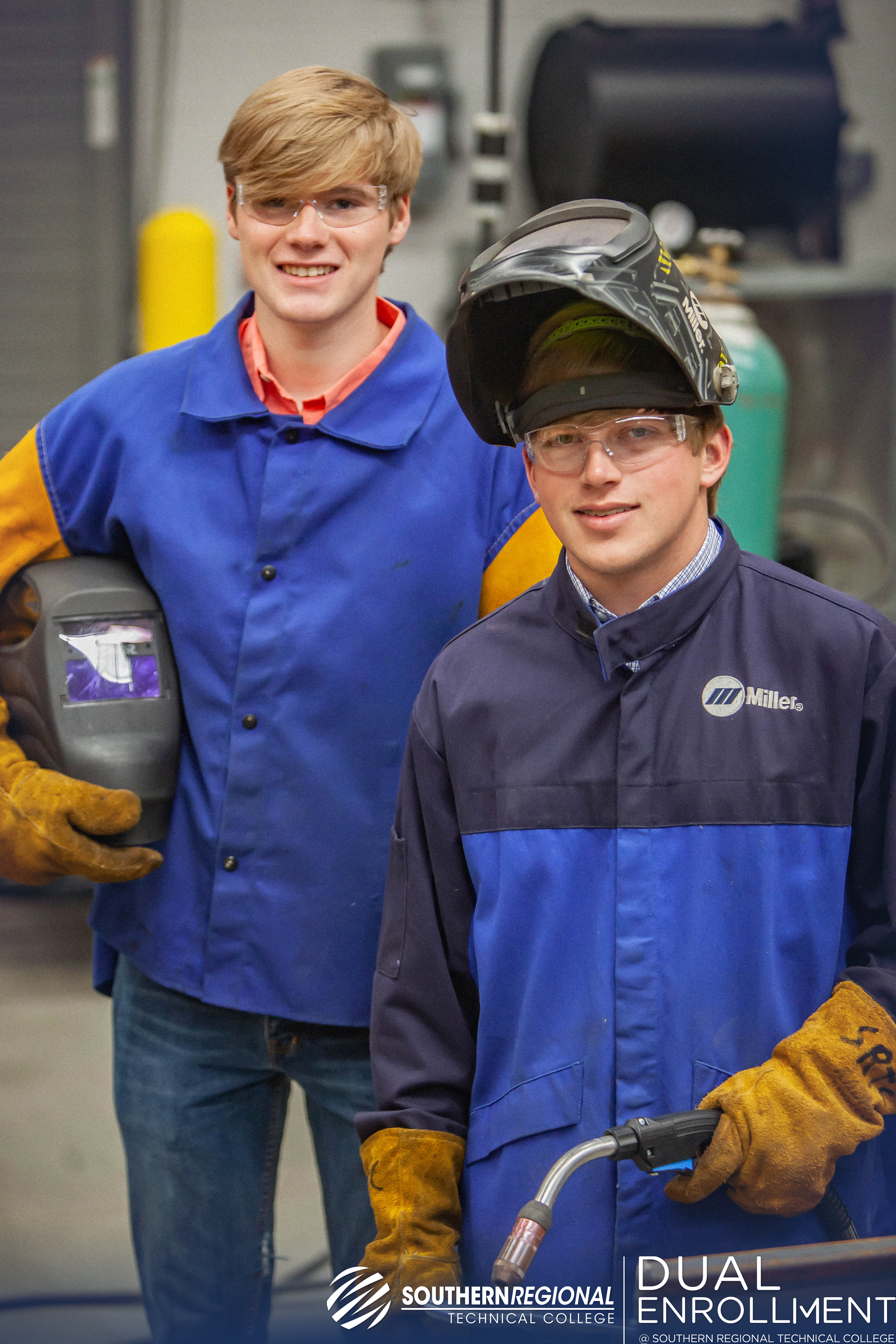 Two male students in welding uniforms