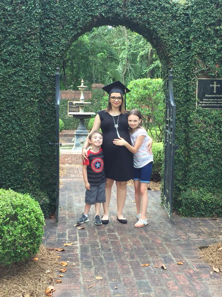 Graduate Marlana Bays in the garden of All Saints Church with her son and her daughter. 