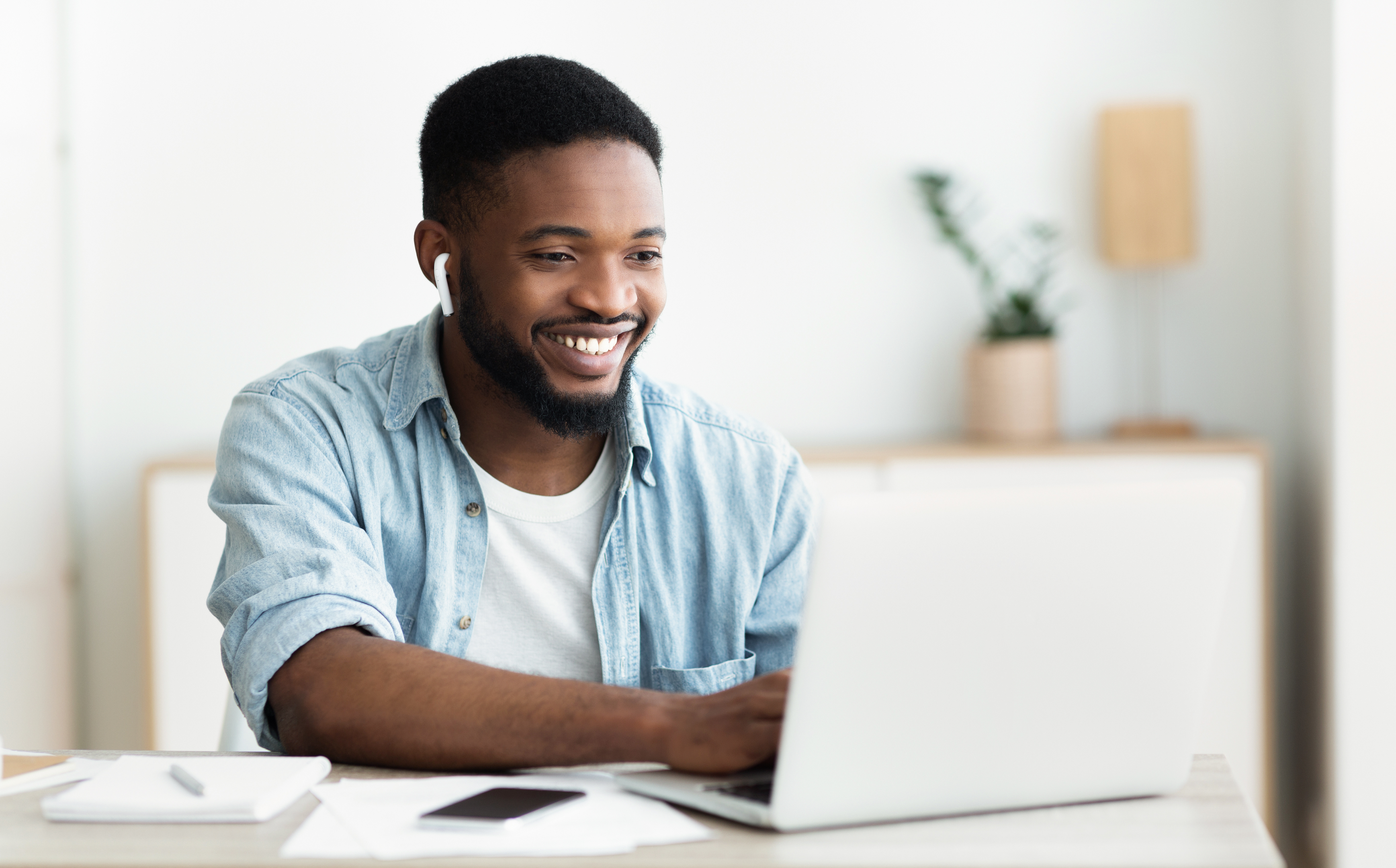 male looking at computer smiling