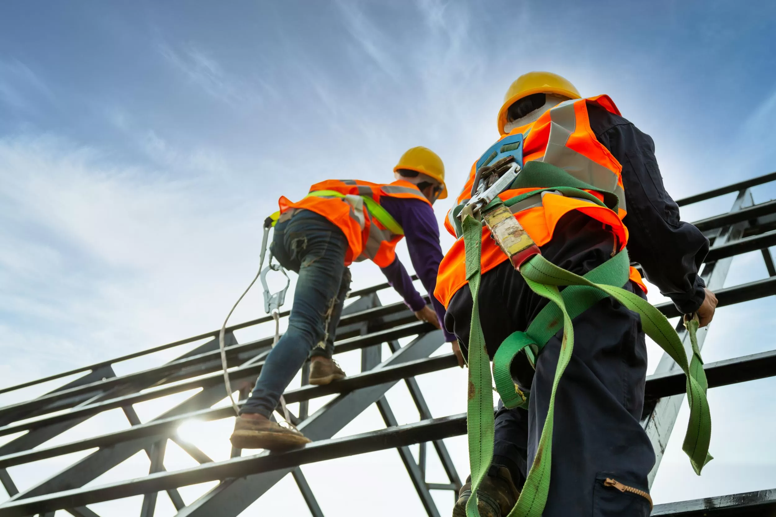 Photo of men in safety gear climbing